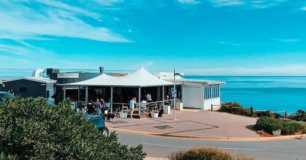 The Star of Greece restaurant on the clifftop at Port Willunga, umbrellas out and the sea beyond