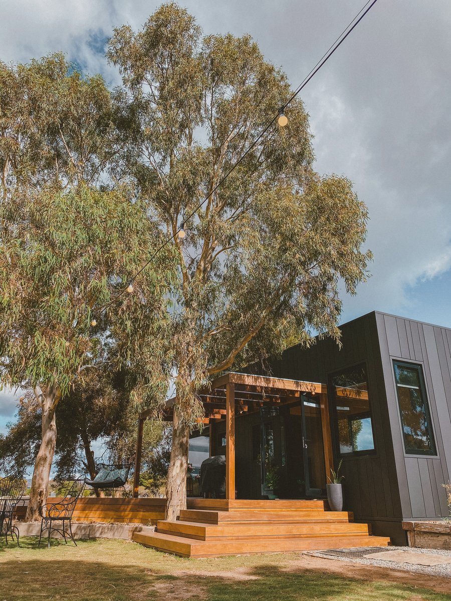 The cabin and deck from the side, gum trees overhead