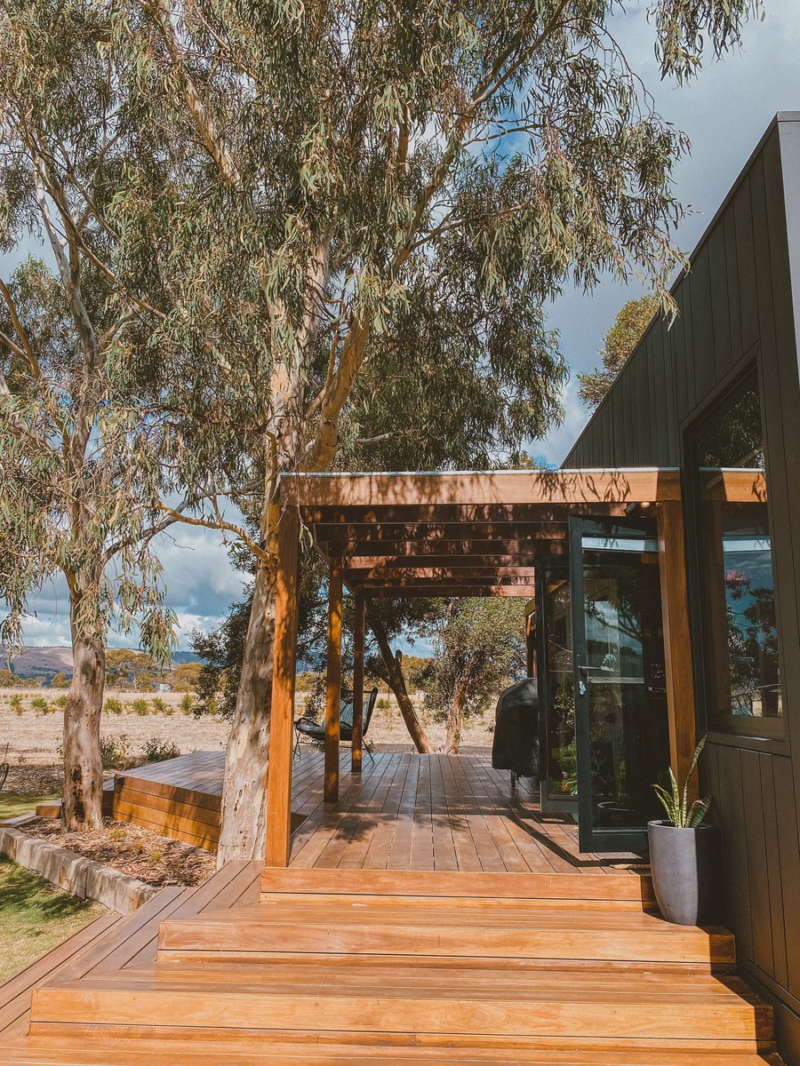 The deck and steps under the gums, the cabin's glass doors open