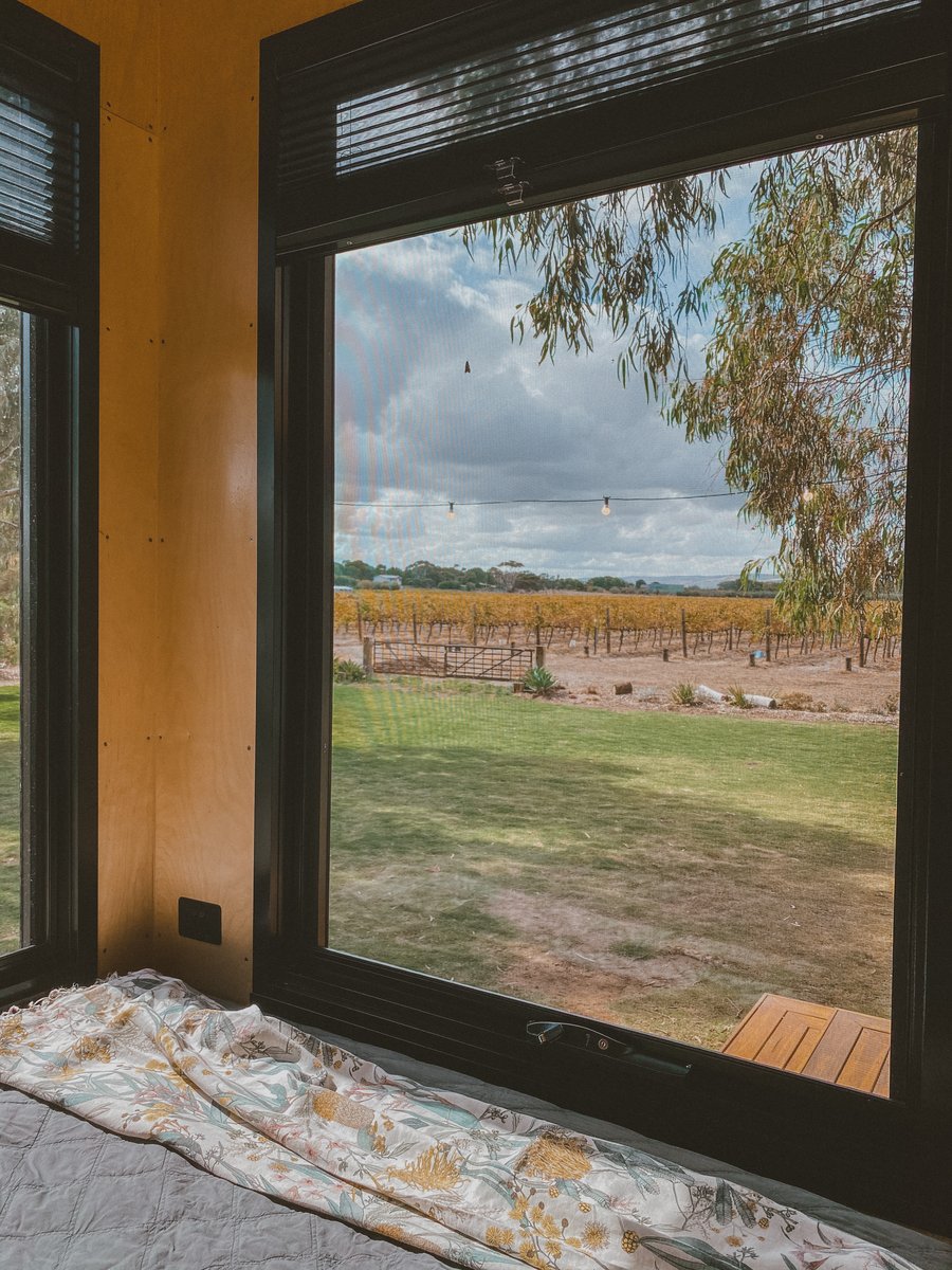 The big window by the bed looking out over the lawn to the vineyard